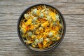 Calendula flowers. Bowl of dry marigold petals on wooden board. Top view. Herbal medicine Royalty Free Stock Photo