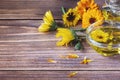 Calendula herbal infused oil made of Calendula officinalis flowers on wooden background, copy space Royalty Free Stock Photo