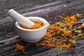 Calendula officinalis - Calendula flower petals in a mortar Royalty Free Stock Photo