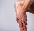 Calf muscle pain. Man hand holding leg with red point closeup. Joint injury during training. Health care, treatment Royalty Free Stock Photo