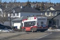 A Calgary Transit bus on the route in a neighbourhood in the NW of the city of Calgary