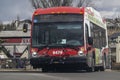 A close up to a Calgary transit bus on the route at a neighbourhood in the Northwest of