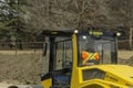 A construction worker driving a BOMAG Single drum roller for soil compaction