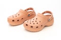 Front view of a couple of Pink Crocs Sandals on a white table Royalty Free Stock Photo