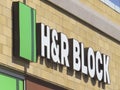 A side view of a H and R Block location sign. Concept: Tax Season