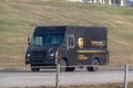 An United Parcel Service or UPS delivery and shipping truck on the road Royalty Free Stock Photo