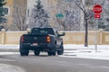 A close up to a Dualie 6x4 truck, featuring dual rear wheels, traversing wintry road