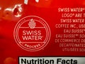 A close up to a Swiss Water Process logo from a Tim Hortons Decaf Coffee package