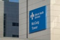 The McCaig Tower with an Alberta Health Services sign at the top of a hospital building in