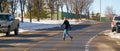 A pedestrian Jaywalking a road during winter season. Jaywalking is Walking in or crossing