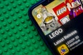 A close up to the Lego application on a iPhone X screen with a green brick background