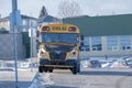 A parked School Bus in front of the Hidden Valley Public School in the North West of