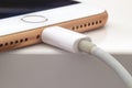 Close up over view of an iPhone Plus charging with a lightning USB Cable