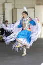 A full view of an indigenous women talent showcase, wearing a blue traditional cloths