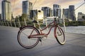 A Huffy Cruiser bicycle parked on a downtown bridge Royalty Free Stock Photo