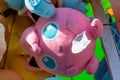 A Jigglypuff pokemon stuffed plush toy offered as a prize for winning a carnival game