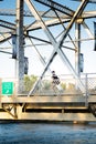 Pedestrian walking across the Reconciliation Bridge while texting