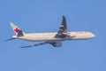 An Air Canada plane flying on clear sky Royalty Free Stock Photo