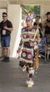 An Indigenous young man talent showcase wearing a white traditional cloths. National