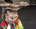 A medium shot of a indigenous kid talent showcase wearing a yellow traditional cloths