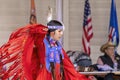 A medium shot of an indigenous woman talent showcase wearing a red traditional dress.