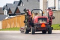 A person driving a big mower on the route during spring