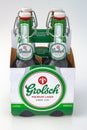 Four pack of Grolsch premium lager bottle with a flip-top closure on a white background