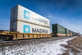 Calgary Alberta Canada, March 02 2022: A pair of Maersk shipping containers on a railway freight line.