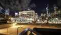 Downtown plaza at night with horse sculptures