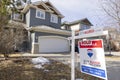 A REMAX Realtor Sign of a Sold property during winter