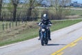 A biker riding a sport motorcycle on the route during spring