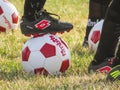 A kid using Lotto Storm Firm Ground Soccer Cleats Shoes. Concept: Football soccer season Royalty Free Stock Photo