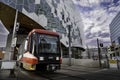 A light rail transit train exits a tunnel from under the central downtown public library. Royalty Free Stock Photo