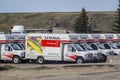 Side view of several U-Haul trucks parked in a storage facility