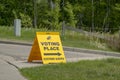 Side view to a Voting Place Elections Alberta sign, yellow double sided floor stand