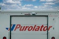 A Close up to a Purolator logo on a delivery truck on a sunny day