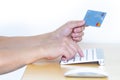 A Person online shopping with a Master Card, credit card and a computer