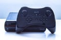 A Wii U console game with a control remote on a white table Royalty Free Stock Photo