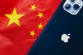 A China flag with an Apple iPhone Max Pro 11. Concept: Apple business relationship with Royalty Free Stock Photo