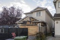 A neighborhood garage roof, which bears the scars of recent accidental fire damage,