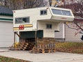 A Scamper truck campers in a garage