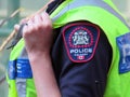 A close up to a female Calgary police officer badge on duty