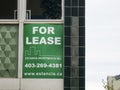 A green color: For Lease office space, sign. Concept: Downtown office vacancy rate in major