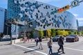 People crossing the street in front of Calgary Public Library