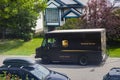 UPS delivery Truck parked by the side of the road in front of residential area. With people inside the vehicle. Royalty Free Stock Photo