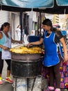 Women cooking and selling roasted ripe plantain at Cali city center