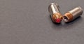 A 40 caliber hollow point bullet and a 44spl red tipped bullet laying together Royalty Free Stock Photo