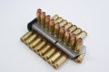 45 caliber hollow point bullets and clip on a white background.