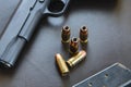 .45 Caliber hollow point bullets near handgun and magazine on le Royalty Free Stock Photo