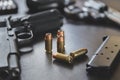 .45 Caliber hollow point bullets near handgun and magazine Royalty Free Stock Photo